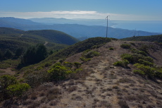 Trail heads downhill along the power lines.
