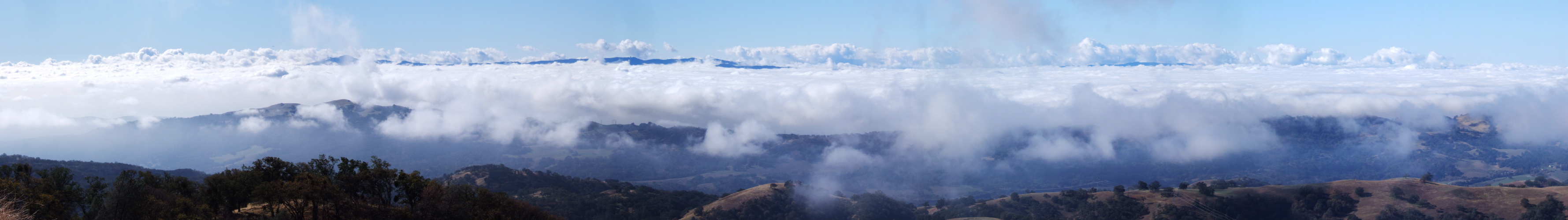Fog burning off, revealing the land below.