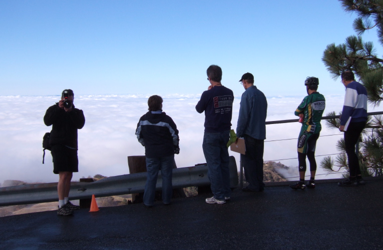 Low-Key staff watching the leaders wind their way up the road.