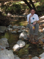Zach resting by the creek, contemplating the serenity