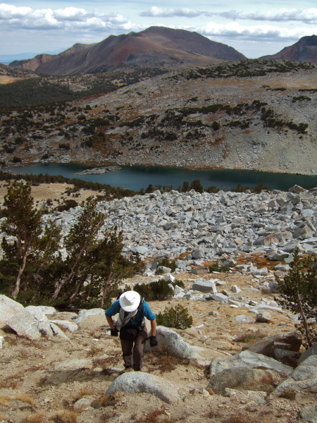 Frank climbs the steep sandy slope above Kuna Lake.