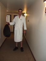 Bill carries out the garbage on his way to the spa.