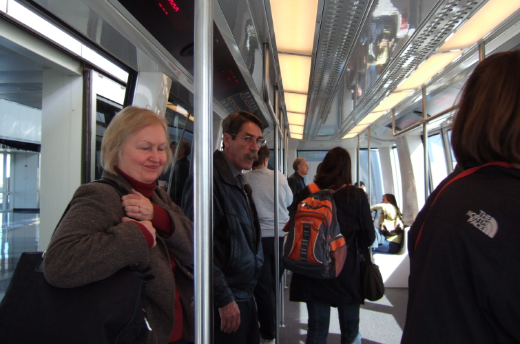 Travelers entering the Skylink train.