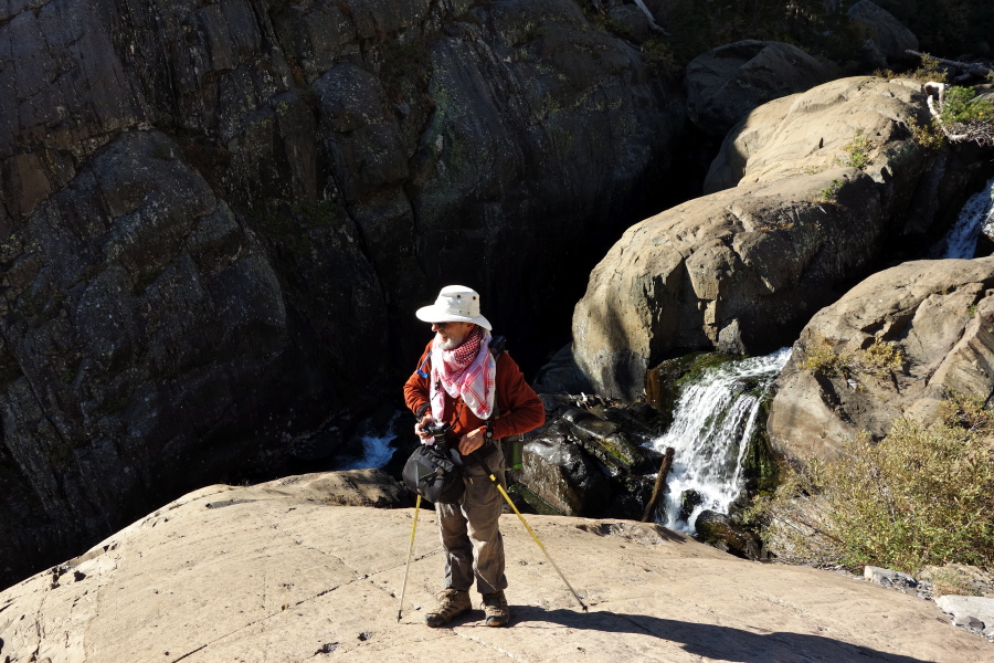 Frank ventures down the highly-sloped rock to get close to the creek.