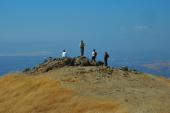 Marty investigates the viewfinders on the north summit while Michi and Ron look on.