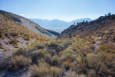 If one looks carefully, the old alignment can be seen.  And, one knows from the climb that the new and old roads join at the pass.  Otherwise it's easy to miss leaving the new road (at left) for the old (covered with shrubs).