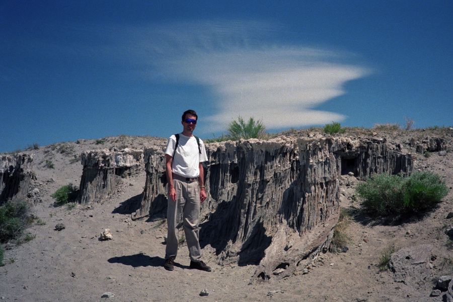 Bill stands next to sand tufa.