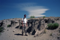 Bill stands next to sand tufa.