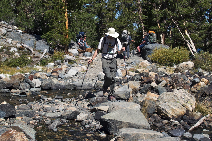 Bill crosses the creek on the stones.