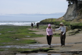 Laura and David walk along the base of East Cliff Drive.