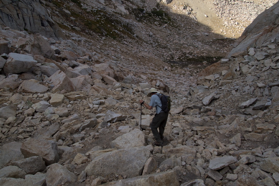Bill picks his way down the rocky slope.
