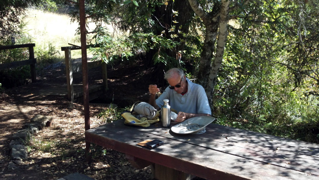 David stops to eat lunch at the convenient picnic table and adjacent hat rack.