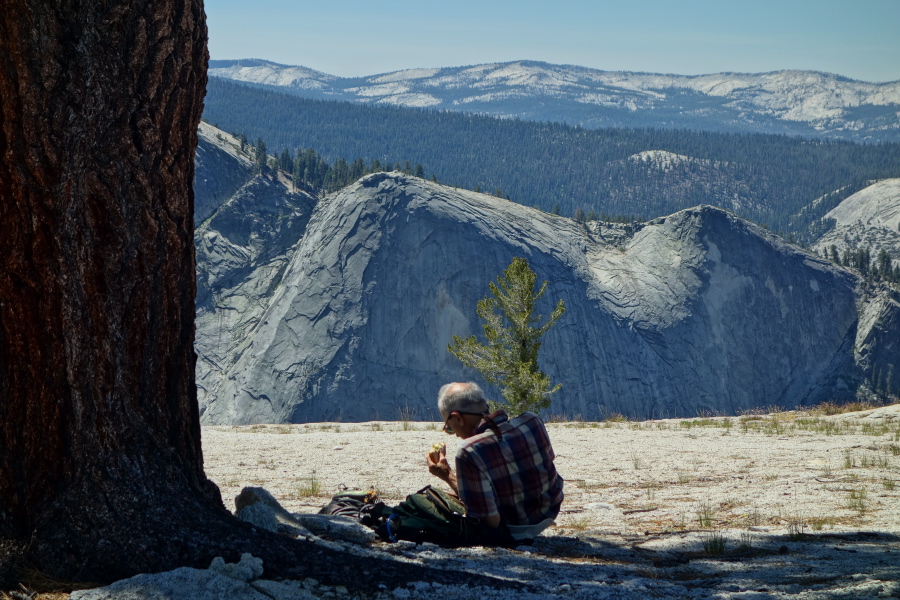 David eats lunch on Mount Watkins with a view of Quarter Domes