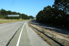 About to cross two lanes of freeway traffic