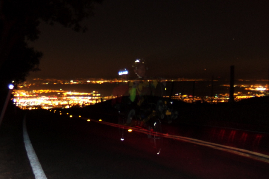Ghost tandem riders climb Sierra Rd. in the dark.