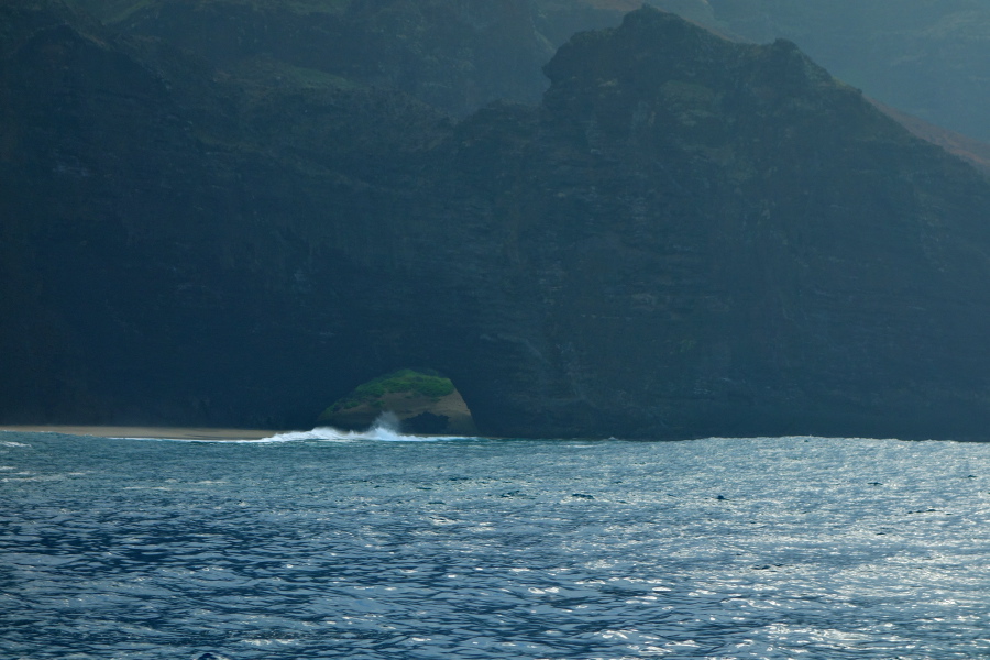 Natural tunnel through the rock separating the two sides of Honopu Beach