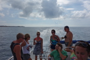 Laura stands at the stern with other tourists.