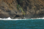 Waterfall into the ocean and a lava bridge.