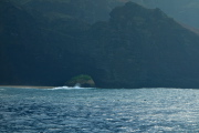 Natural tunnel through the rock separating the two sides of Honopu Beach