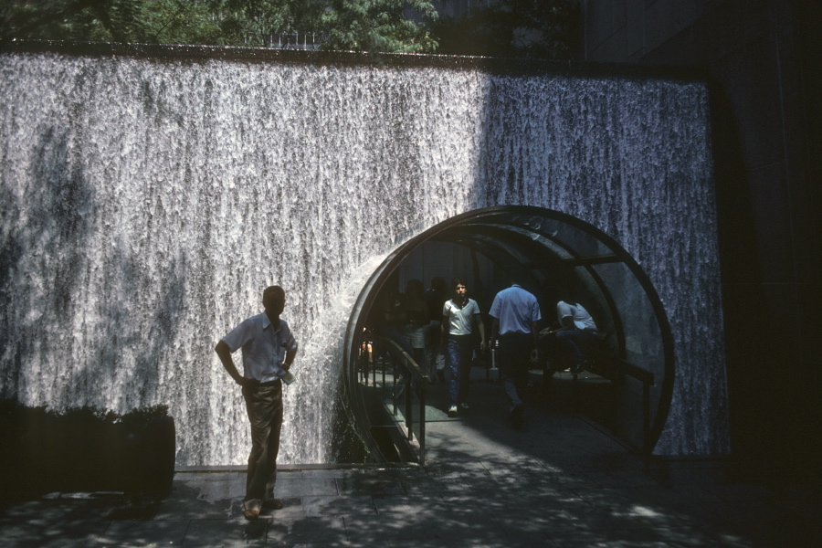 A walkway through a waterfall at Rockefeller Center