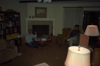 Chris finishes his pizza while Vasu waits for the festivities to begin.