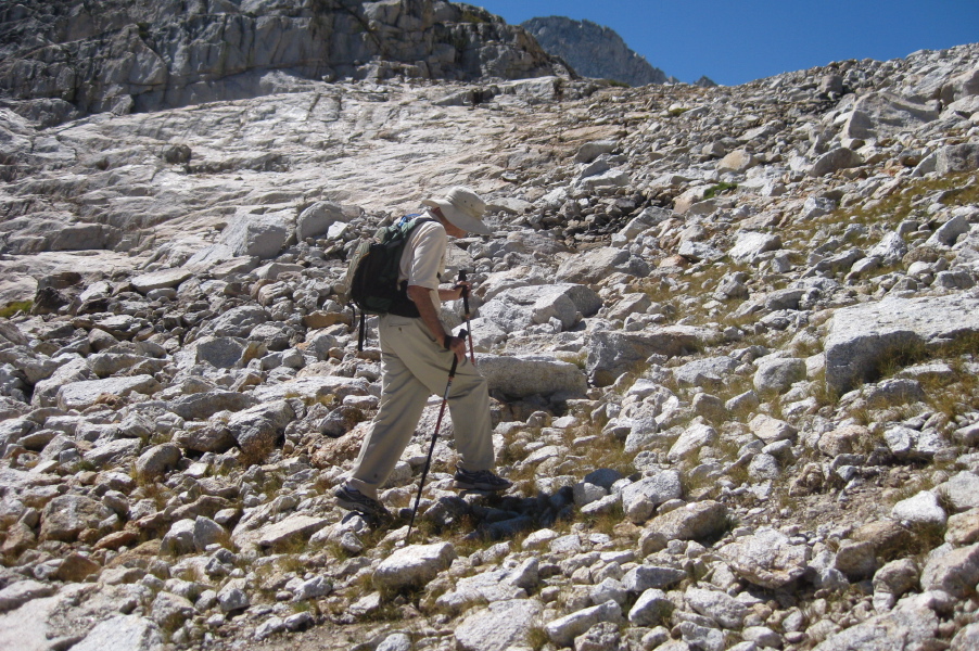 David climbs up the rocks.