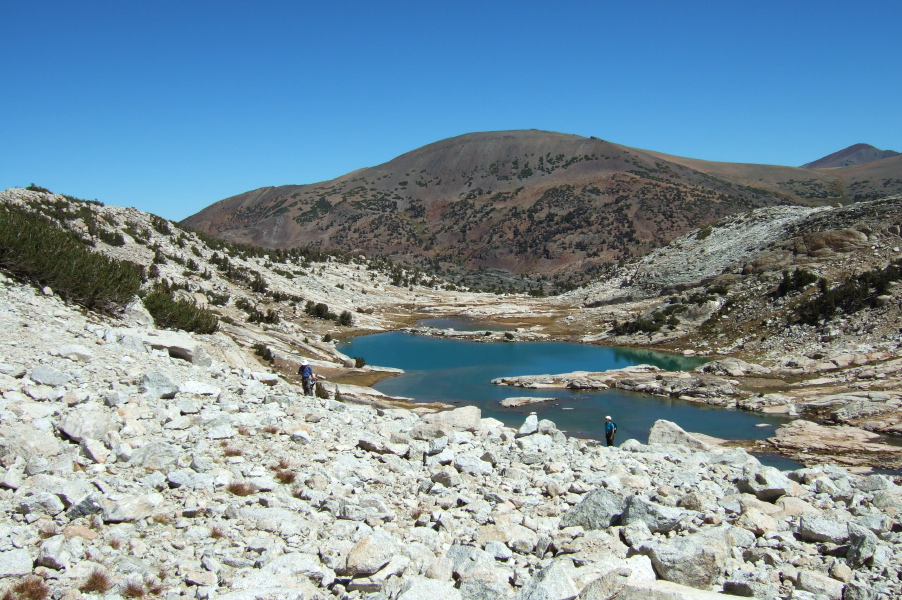 Frank and Stella climb the talus field to the upper Conness Lake.