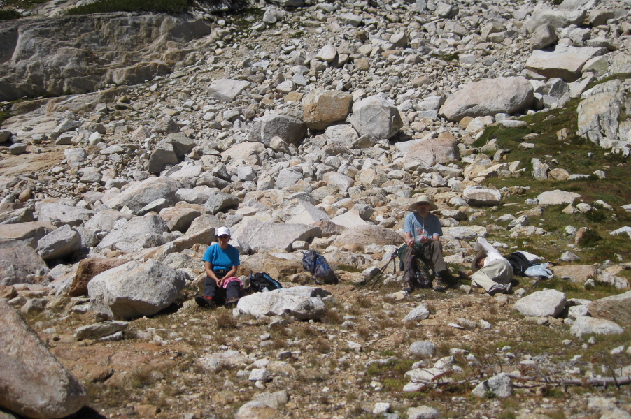 Stella, Bill, and David (lying down) rest and eat lunch before starting the hard part of the climb.