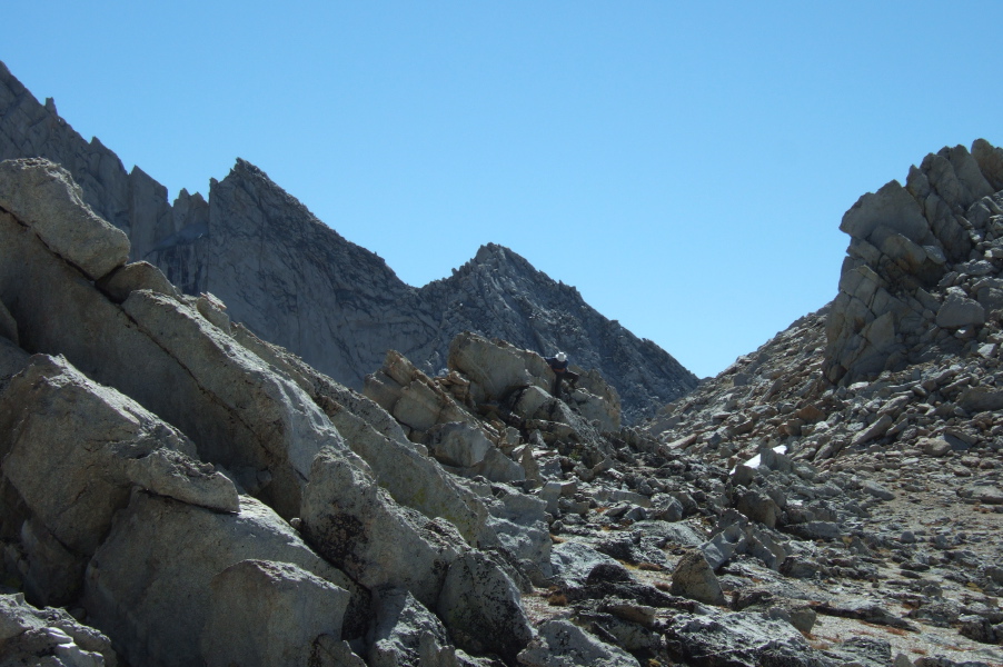 Frank scrambles down from one of the pinnacles near the low point of the ridge