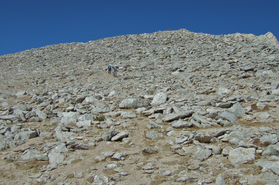 Frank and Stella hike down from the summit.