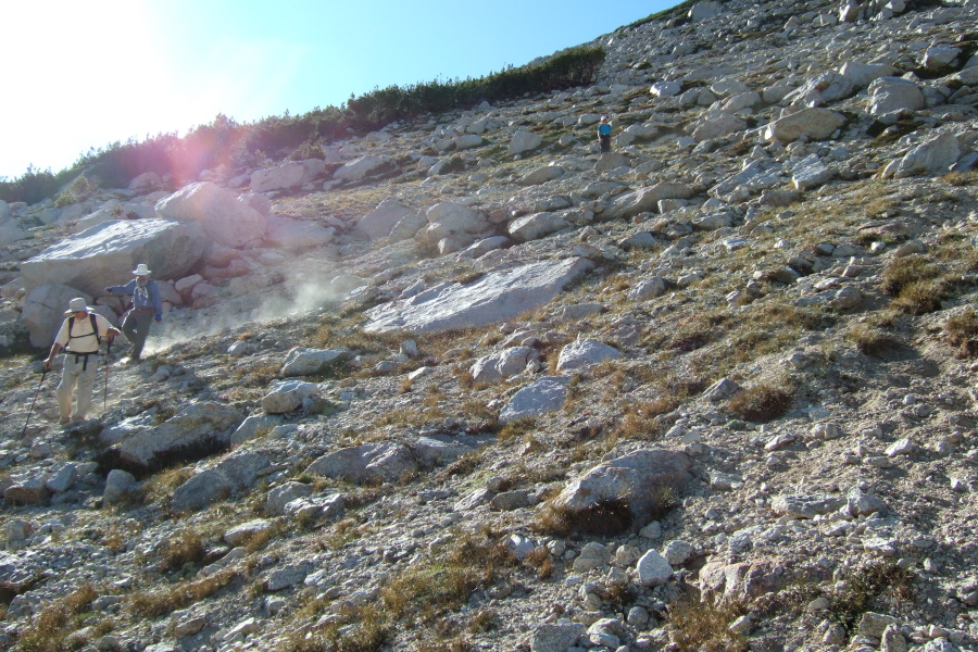 David, and Frank kick up a dust storm sliding down the slope.