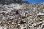 David climbs up the rocks.