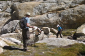 Bill watches everyone cross the stream at the top of the canyon.