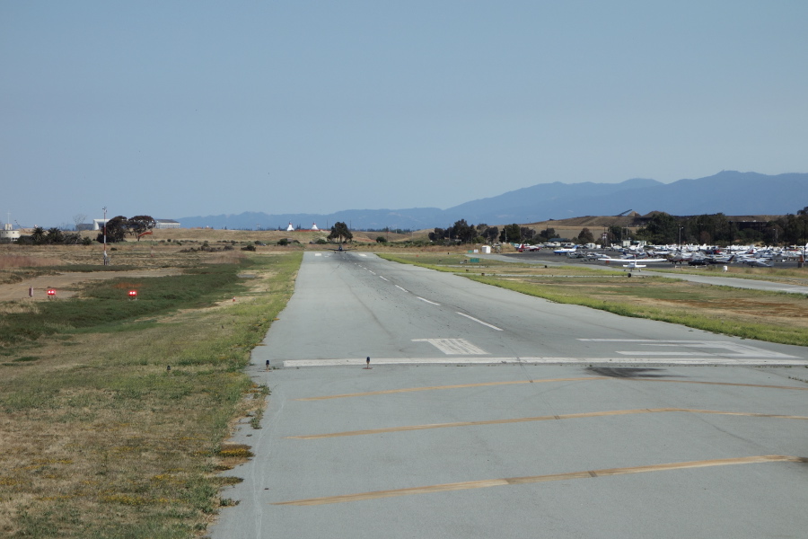 Old WWII navy plane begins its takeoff roll.