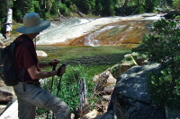 Bill pauses by the granite slide and pool at the top of Illilouette Fall.