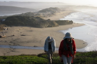 David and Kay climb the bluff at the north end of Pescadero Beach.