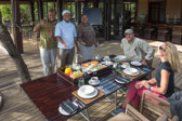 Lodge staff: Michael (monkey slingshot in hand), Chef Magic, and Jabu.