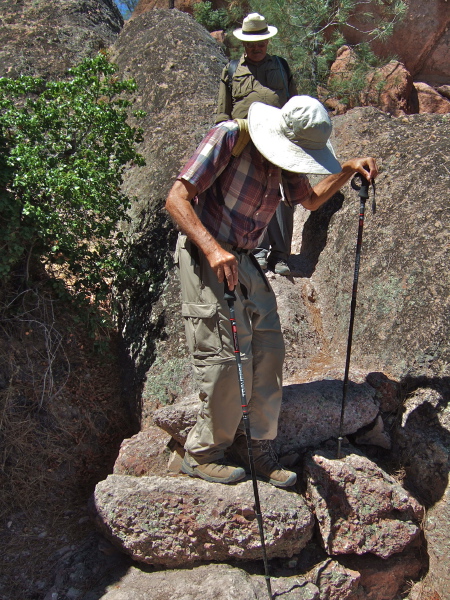 David uses sticks to help with balance when descending the large stone steps.
