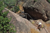 David climbs the first steep stairway with railing.
