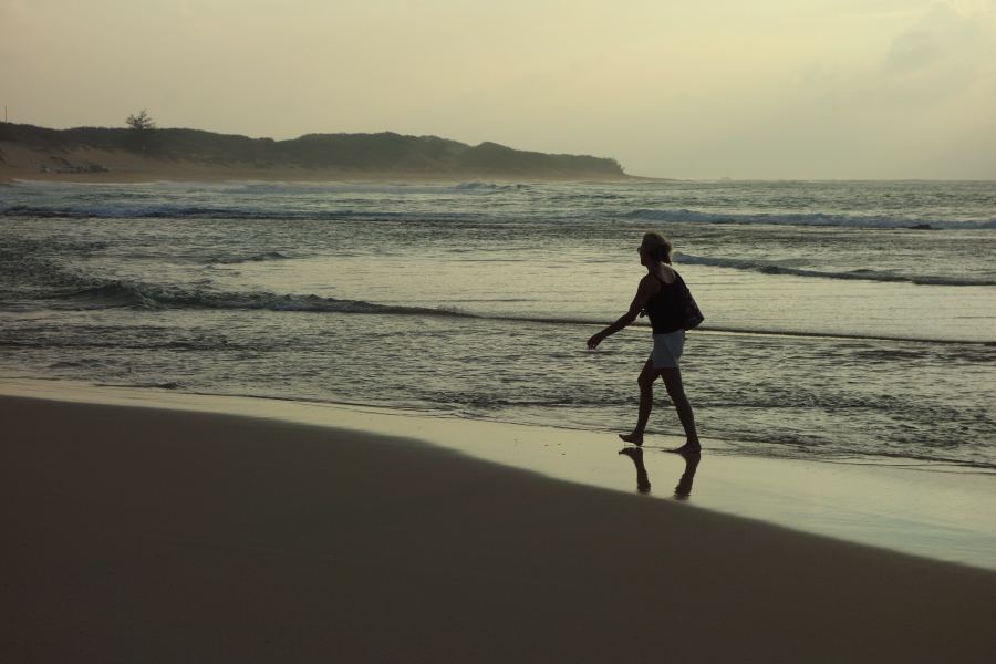 Laura dips her feet in the water one last time before climbing the dune back to the car.