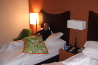 Dad relaxes in bed before the long drive home.