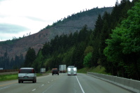 Clearcut on hillside near freeway.