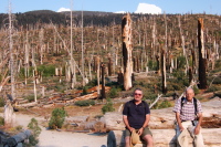Ron and David sit amidst the ruin of the Rainbow Fire.
