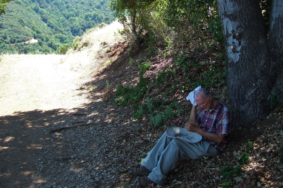 David takes a rest from the hot trail in the shade.