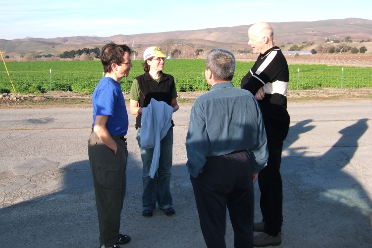 Dan Connelly and Cara Coburn chat with John Curd and Joseph Maurer (back to camera).