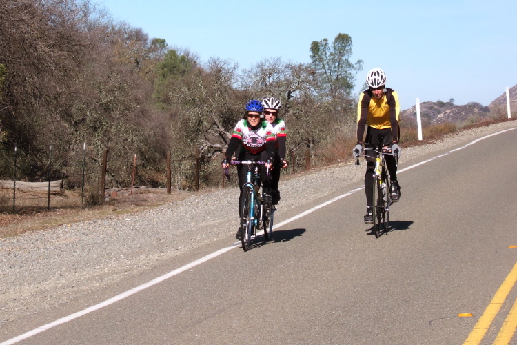 Lisa Antonino and T Lynch, and another cyclist reach Rabbit Summit.
