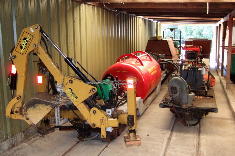 Backhoe, water tank, and leaf blower.