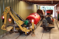 Backhoe, water tank, and leaf blower.