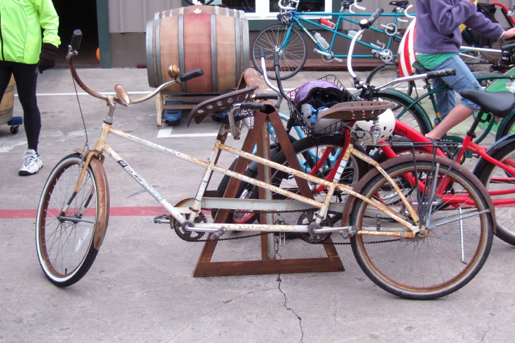 Rusty old tandem with tractor seats.