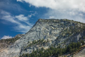 Yet, my legs, tired from a week of hiking and biking and unsure of my safely climbing the highly-sloped granite slabs, say too far today.
